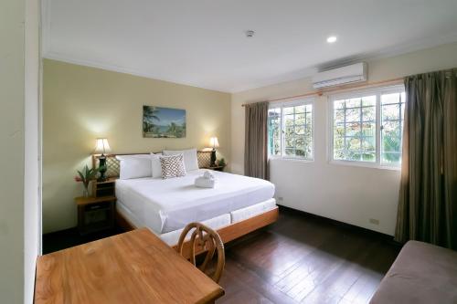 博卡斯德尔托罗格兰巴伊亚酒店的卧室配有床、桌子和窗户。