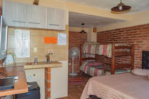 圣罗莎卡拉穆奇塔县Posada Tinktinkie的带卧室、床和厨房的客房