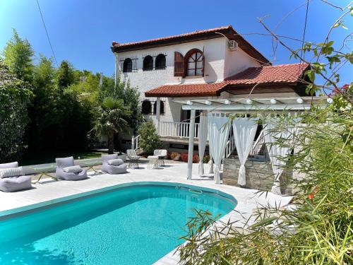 斯卡拉索提罗斯Byblos Mare-The Exclusive Beach Front Villa的别墅前设有游泳池