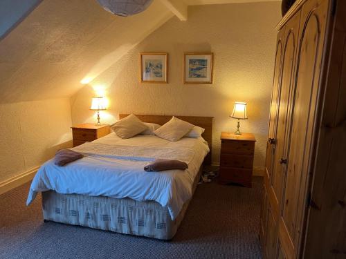 贝尔法斯特Cosy Town House的一间卧室配有一张带2个床头柜和2盏灯的床。