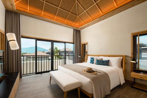 三亚 三亚1Hotel海棠湾阳光壹酒店（可持续发展理念）的一间卧室设有一张大床和一个大窗户
