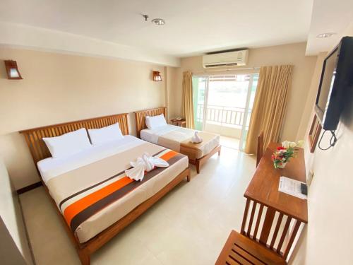 北榄坡Maihom Resort Hotel的酒店客房设有两张床和电视。