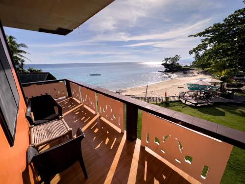 安达1peace beach resort的阳台设有长椅,享有海滩美景