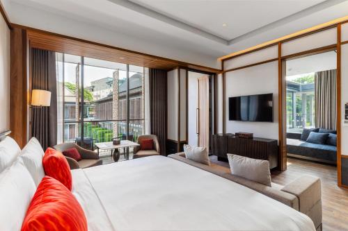 曼谷Villa Deva Resort & Hotel Bangkok的酒店客房设有一张大床和一台电视机。