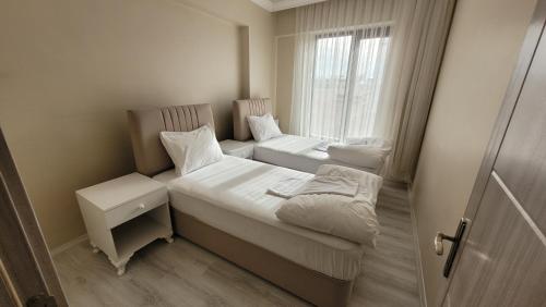 凡城Padishah Suite Otel的小房间设有两张床和窗户