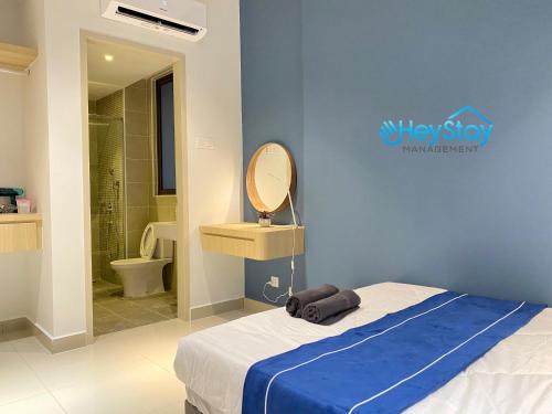 马六甲Bali Residence Melaka By Heystay Management的一间卧室配有一张蓝色墙壁的床