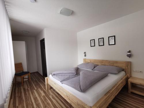 尼德泰福克纳曼努埃尔公寓的一间卧室配有一张带蓝色枕头的木床。