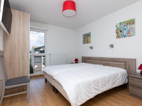 卡布勒通Appartement Capbreton, 3 pièces, 4 personnes - FR-1-239-387的白色的卧室设有一张大床和一个窗户