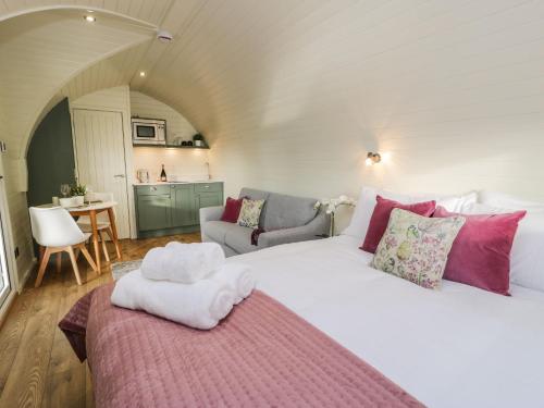 里辛Yr Onnen的卧室配有带粉红色枕头的大型白色床