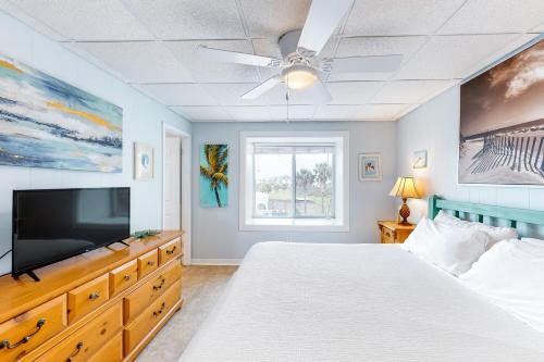 马士腾海滩Seaside Pearl的一间卧室配有一张床和一台平面电视