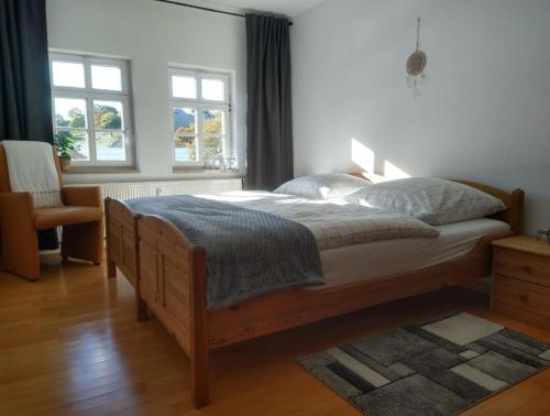 爱尔福特Appartement DOM II - Erfurt Domplatz的一间卧室配有一张床、一把椅子和窗户。