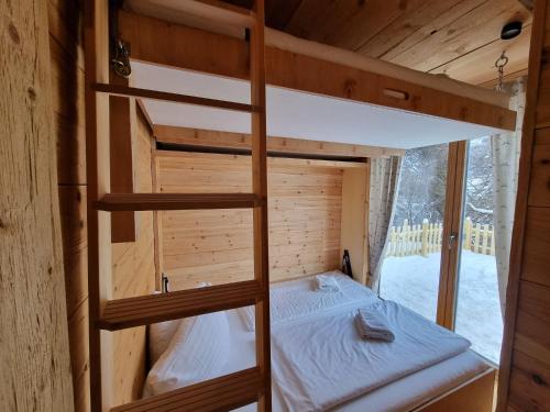 海因岑贝格Chaleny - Das erste Tiny House Chalet im Zillertal的小屋内设有一间带两张双层床的卧室