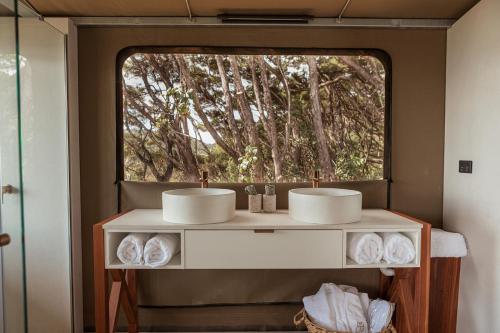 TarakoheDrift Off Grid Luxury Eco Glamping的一间带两个盥洗盆和窗户的浴室