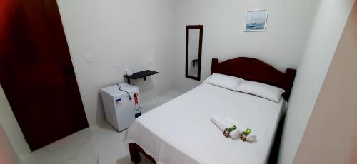 巴雷里尼亚斯Pousada Brilho dos Lençóis的白色的小房间,配有床和冰箱