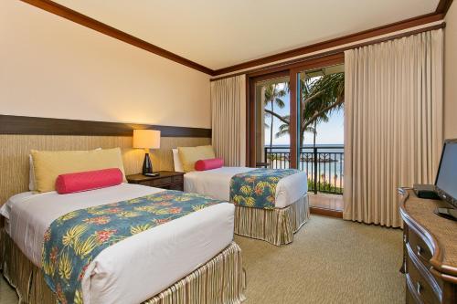 卡波雷Ko Olina Beach Villas B210 - Beach Front Luxury 2BR 2BA Condo with 1 Free Parking的酒店客房设有两张床和一个阳台。