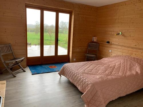 Jeux-lès-BardChambre d'hôtes dans les champs的一间卧室设有一张床和一个大窗户