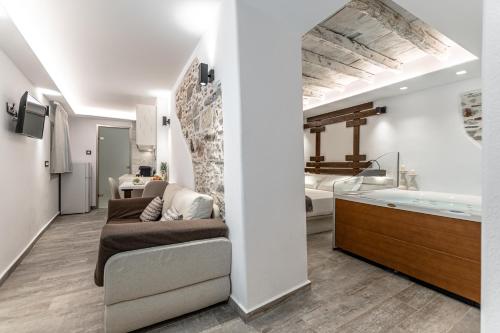 纳克索乔拉Mariet Naxos Spa & Suites的带沙发和浴缸的客厅