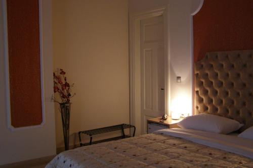 卡斯托里亚Room in Faneromeni's grove的一间卧室,配有一张床和花瓶
