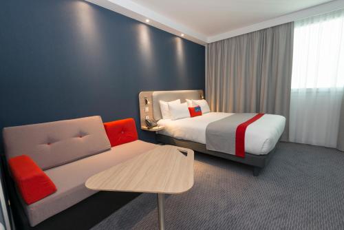 韦利济·维拉库布莱巴黎智选假日酒店 - 韦利济的酒店客房,配有床和沙发