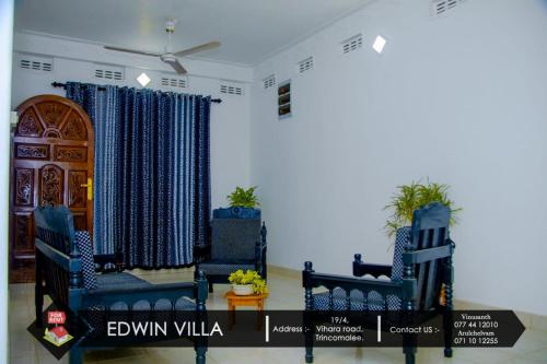 亭可马里Edwin Villa的一间设有两把蓝色椅子和一扇门的房间