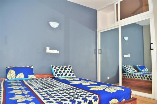 洛美RÉSIDENCE BELLEVUE SITO AIPORT- Lomé的蓝色的客房配有蓝色和白色枕头的床