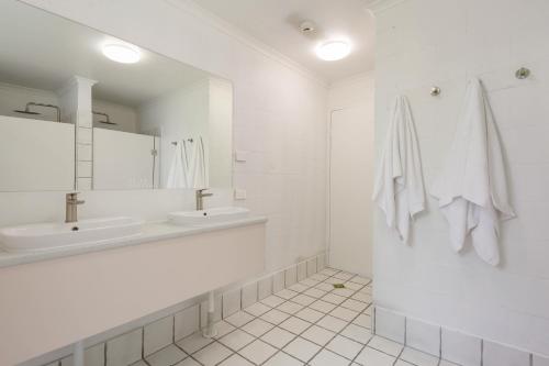 穆卢拉巴Abode Mooloolaba, Backpackers & Motel rooms的白色的浴室设有水槽和镜子