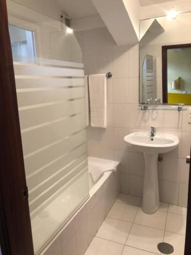 丰沙尔Residencial Chafariz /Queimada的白色的浴室设有水槽和淋浴。