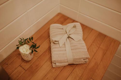 维罗纳Casa Sgarzarie exclusive apartment的木地板上带弓的毛巾