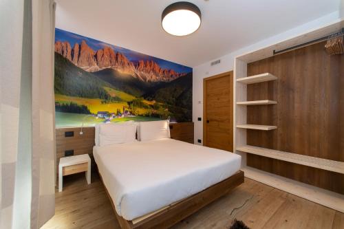特伦托YUGOGO PELLICO 8 Trento Centro的卧室配有一张床,墙上挂有绘画作品