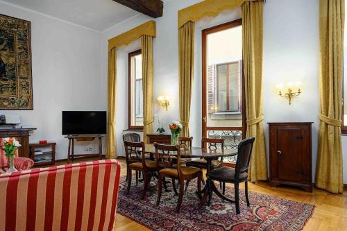 米兰Piazza DUOMO - Antico Appartamento dell'800的客厅设有餐桌和椅子