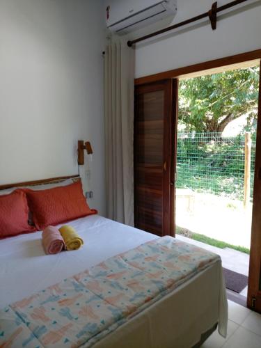 伊尔哈德博伊巴Cafofo de Dri的一间卧室设有一张床和一个滑动玻璃门
