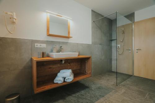 滕嫩山麓圣马丁埃德尔旅馆的一间带水槽和淋浴的浴室