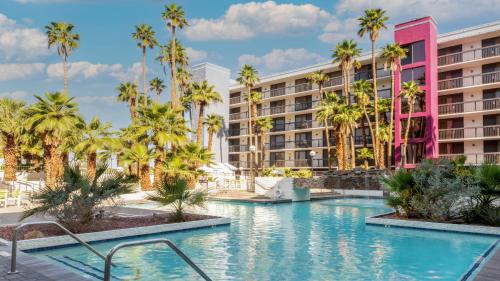 梅萨Holiday Inn & Suites Phoenix-Mesa-Chandler, an IHG Hotel的酒店前方的棕榈树游泳池