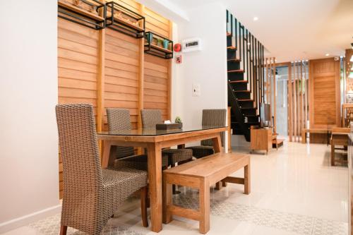 曼谷Cozy House City center BTS&MRT的一间带木桌和椅子的用餐室