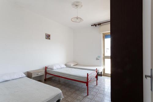 托雷莫泽Trilocale con vista mare e spiaggia的一间卧室设有两张床和窗户。