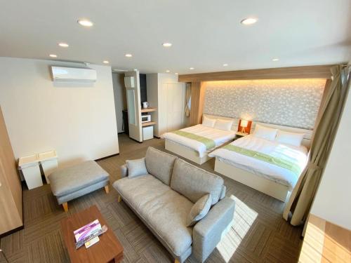 东京Sugamo Winco Residence的酒店客房,配有床和沙发