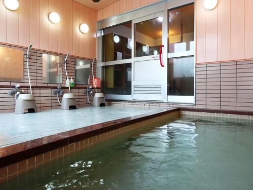 小谷村梅里贝勒栂池酒店的一座建筑物中央的游泳池