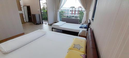 邦美蜀Đồi Sao Homestay的客房设有两张床和大窗户。