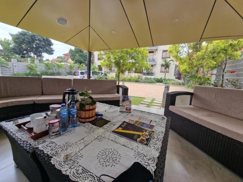 坎帕拉Eric Wilkins Apartments的露台上的桌子和遮阳伞