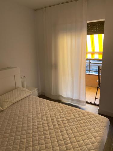普拉加德阿罗Apartamento alto standing con piscina privada, aire acondicionado y wifi的一间卧室设有一张床和一个美景窗户。