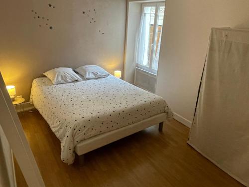 沙布利L'eutopia au cœur de Chablis, parking gratuit的小卧室配有带2个枕头的床和窗户