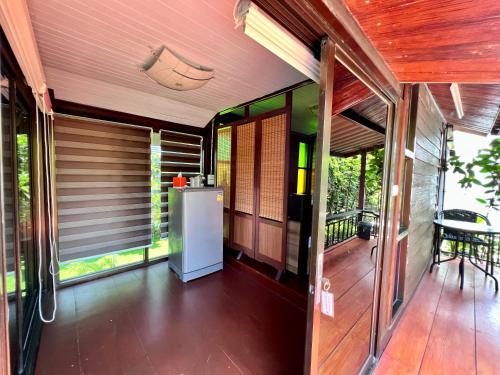 三帕兰MrT Riverside Sampran มิสเตอร์ที โฮมสเตย์-ช้องนาง的门廊上配有冰箱的房屋外景