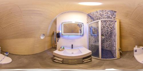 锡吉里亚NIVADOO RESORT SIGIRIYA的圆形浴室设有水槽和淋浴。