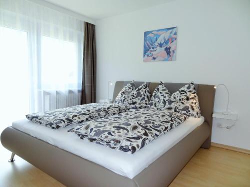 因斯布鲁克Holiday flat, Axams的一张配有黑白床单和枕头的床