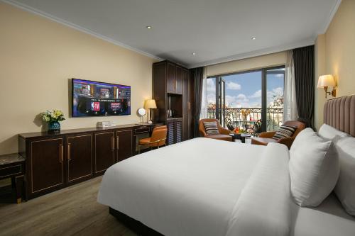 河内San Palace Hotel & Spa的酒店客房设有白色的床和电视。