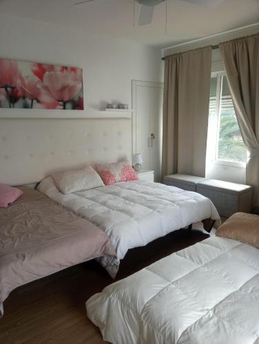 科尔多瓦Chalet Urbanización Alcolea的一间卧室设有两张床和窗户。