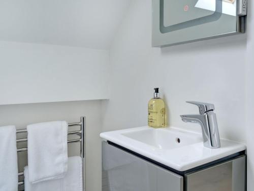 拜伯里Swallows Nest的浴室配有盥洗盆、镜子和毛巾