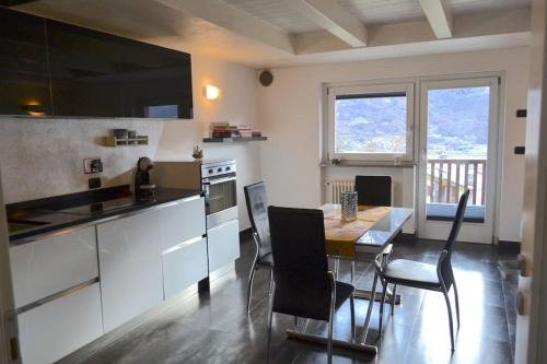 奥斯塔Grazioso appartamento Aosta的一间厨房,里面配有桌椅