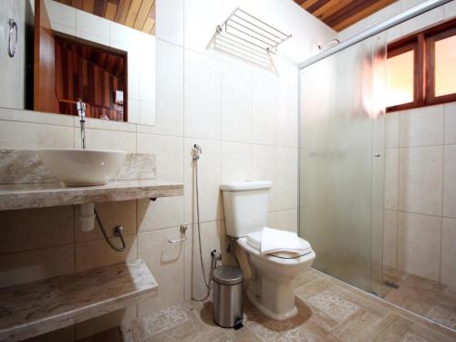 奥林匹亚Pousada Shekinah的浴室配有卫生间、盥洗盆和淋浴。
