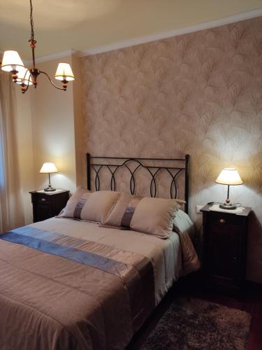 卡尔达斯·德·雷斯Apartamento La Real的一间卧室配有一张带2个床头柜的大床